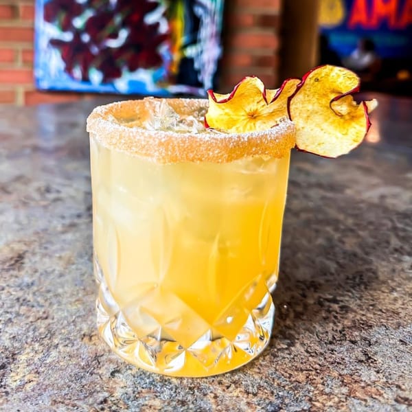 Amaya's Fresh Mexican Grill's golden cocktail with a sugared rim and dried apple garnish.